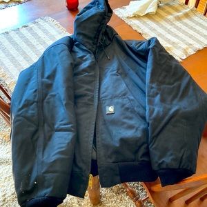 Black 2XL mens hooded Carhartt jacket. Small stain on right sleeve. No returns